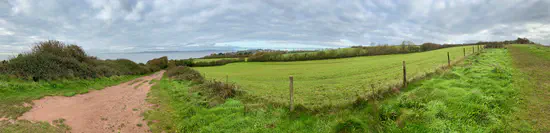 A photograph of the Exe Estuary and fields on the South West Coast Path near Exmouth.